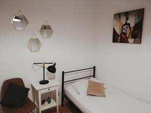 a bedroom with two beds and a chair at Guesthouse Radić in Dubrovnik