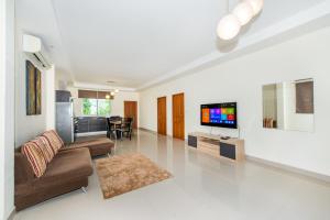 a living room with a couch and a tv in it at Platinum Residence Villa in Rawai Beach