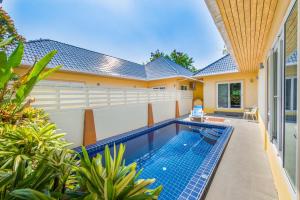a swimming pool in the backyard of a house at Platinum Residence Villa in Rawai Beach
