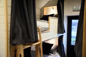 a room with bunk beds in a tiny house at Lodge on the Loch in Sconser