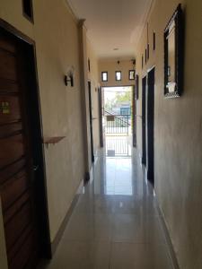 an empty hallway of a building with a door and a hallwayngthngthngthngth at Mina Homestay Syariah in Bukittinggi