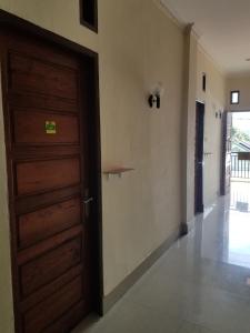 a room with a door and a hallway at Mina Homestay Syariah in Bukittinggi