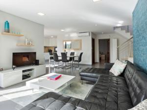 a living room with a couch and a table at Luxury villa with private heated pool in Foz do Arelho