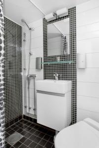 a bathroom with a toilet, sink, and shower stall at Mälardrottningen Yacht Hotel & Restaurant in Stockholm
