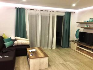 a living room with a couch and a tv at New apartment near the beach in Playa Paraiso in Playa Paraiso