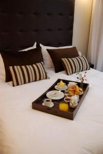 a tray of food on top of a bed at Rendez Vous Hotel Buenos Aires in Buenos Aires