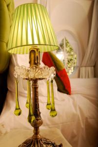 a lamp sitting on a table next to a bed at Rendez Vous Hotel Buenos Aires in Buenos Aires
