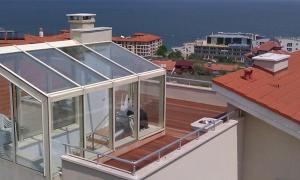 a glass house on the roof of a building at Sun Village Villa 13 in Byala