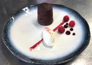 a plate with a chocolate dessert and berries on it at Delphi Lodge in Leenaun