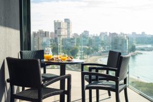 a table and chairs on a balcony with a view at Modern sea front Reef in Alicante