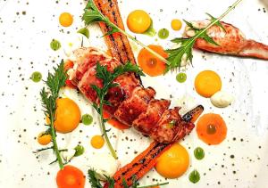 a white plate of food with carrots and meat at Delphi Lodge in Leenaun