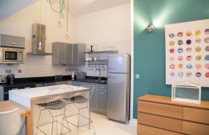 a kitchen with a refrigerator and a table in it at Regent House deluxe 1 bedroom apartment in Harrogate