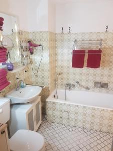 a bathroom with a tub and a toilet and a sink at Komfort Ferienhaus FEWO70 in Bremm +50 photos