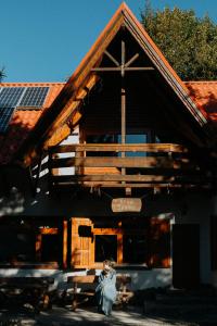 a woman sitting in front of a building at Boutique Guesthouse „Domizil“, Valea Porumbacului in Porumbacu de Sus