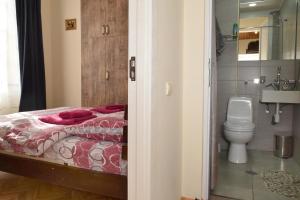 a bedroom with a bed and a toilet at Le Petit in Tbilisi City +131 photos