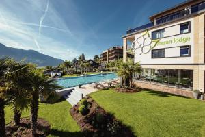 a hotel with a swimming pool and a resort at La Maiena Meran Resort in Marlengo