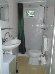 a white bathroom with a sink and a toilet at Rekerlanden 273 in Schoorldam