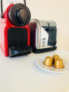 a red and black toaster sitting on a counter at Beau 2 pièces Evry Centre in Courcouronnes