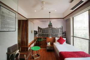 a bedroom with a mural of a building on the wall at Theory9 Premium Service Apartments Khar in Mumbai