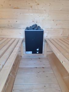 a sauna with a tv in the middle at Colț de rai - camera de inchiriat in Reşiţa