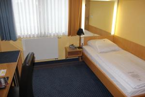 Postel nebo postele na pokoji v ubytování Hotel Victoria