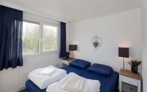 a bedroom with two beds and a window at Siblu Camping de Oase in Renesse