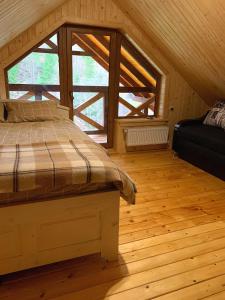 a bedroom with a bed and a large window at Терношорська Лада in Snidavka +215 photos