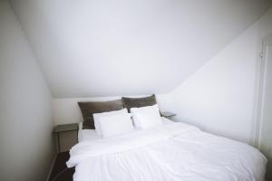 a white bed with white sheets and pillows at Fab scenery in Ballstad