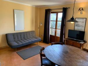 a living room with a couch and a table at Vinauberge in Poilhès