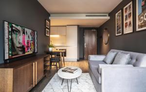 a living room with a couch and a table at The Gate London City in London
