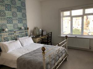 a bedroom with a bed and a window at Hotel 50 in Bournemouth