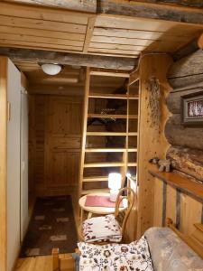 an attic room with a bunk bed and a ladder at Levi Pikkurakka 4A4 in Kittilä