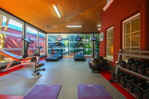 a gym with several treadmills and machines in a room at My Home Apart in Alanya