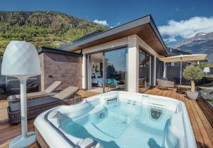 a hot tub on the deck of a house at La Maiena Meran Resort in Marlengo