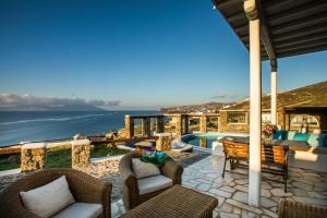 a patio with a view of the ocean at Sunset Villa Iza in Agios Ioannis Mykonos