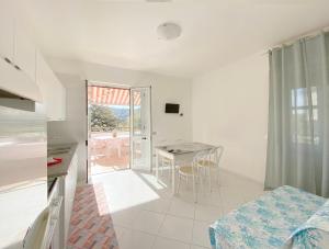 a kitchen and dining room with a table and chairs at Casa Vacanze Angelo in Palinuro