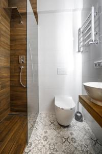 a bathroom with a toilet and a sink at Royal apartment on Hmelnytskogo 37 in Lviv