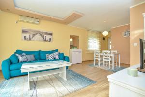 a living room with a blue couch and a table at Branka Apartments in Tivat