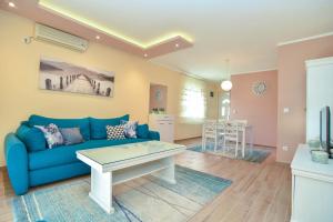 a living room with a blue couch and a table at Branka Apartments in Tivat