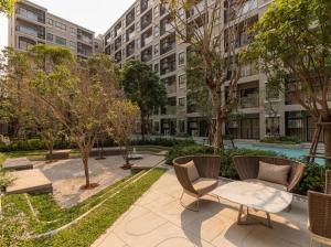 a patio with chairs and a table in front of a building at La casita Hua-Hin seaview by Yaya in Hua Hin