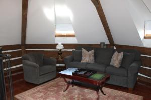 a living room with a couch and a chair and a table at Twin Pine Manor in Ephrata