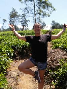 a woman standing on a dirt road with her arms outstretched at Top View in Hatton