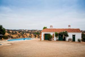 a house with a swimming pool in front of it at Monte da Corte Ligeira in Cabeça Gorda