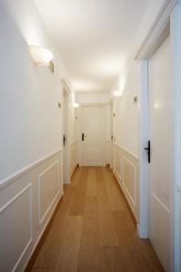 an empty hallway with white walls and wood floors at Hotel Ciudad De Calahorra in Calahorra