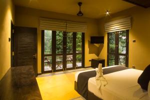 a bedroom with a bed with a bunny head on it at Forest Shade Eco Resort in Deraniyagala