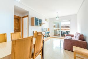 a kitchen and living room with a table and chairs at Vacaciones Oromarina Jardines del Mar in Oropesa del Mar