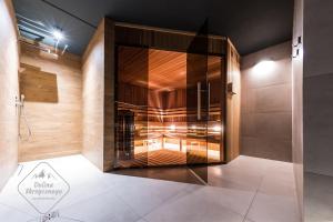 a bathroom with a shower with a glass door at Apartamenty Dolina Skrzycznego in Szczyrk