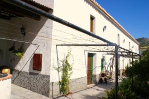 a white building with a pole in front of it at La Cañota 2-Floors King Rooms Adults Only in Talara