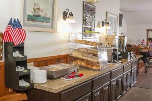 a bakery counter with a bunch of donuts on it at Flagship Inn in Boothbay Harbor