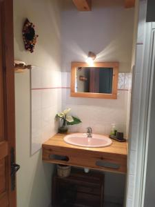 a bathroom with a sink and a mirror at La Roche Meane in Villar-dʼArène